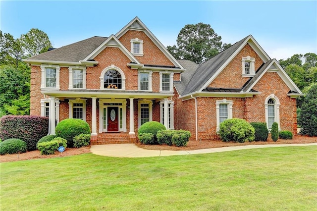 view of front of house with a front lawn and covered porch