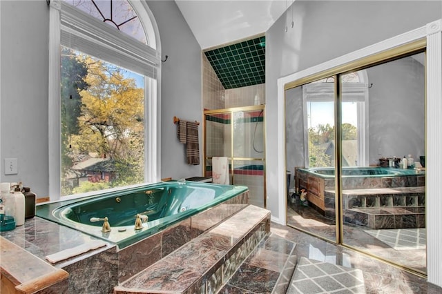 561 Culberson St SW, Atlanta, GA 30310 - full bath featuring marble finish floor, a whirlpool tub, vaulted ceiling, and a shower stall