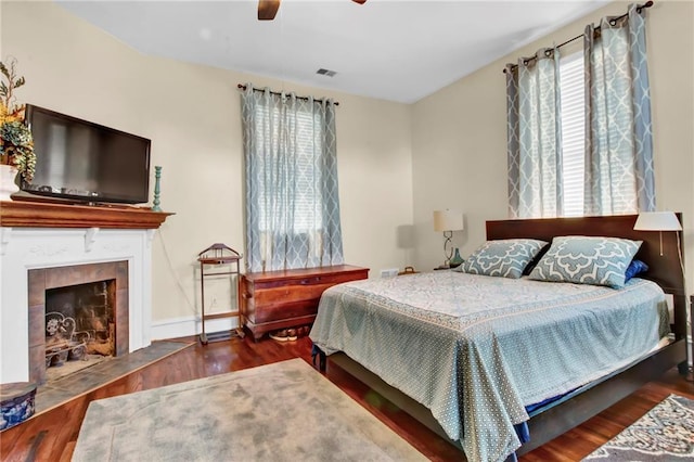 561 Culberson St SW, Atlanta, GA 30310 - bedroom with wood finished floors, a ceiling fan, and a tile fireplace