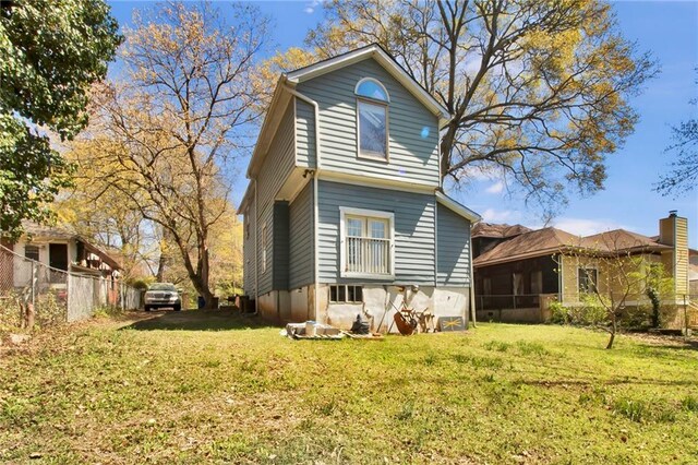 561 Culberson St SW, Atlanta, GA 30310 - rear view of property featuring a lawn, a sunroom, and fence