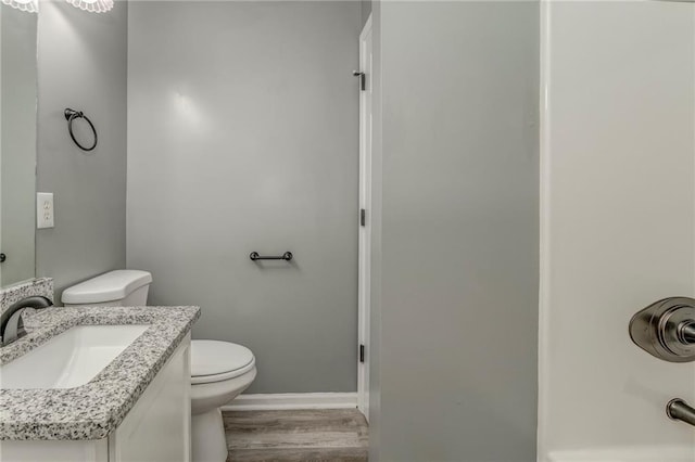 459 Bakers Bridge Cir, Douglasville, GA 30134 - bathroom featuring toilet, wood finished floors, vanity, and baseboards