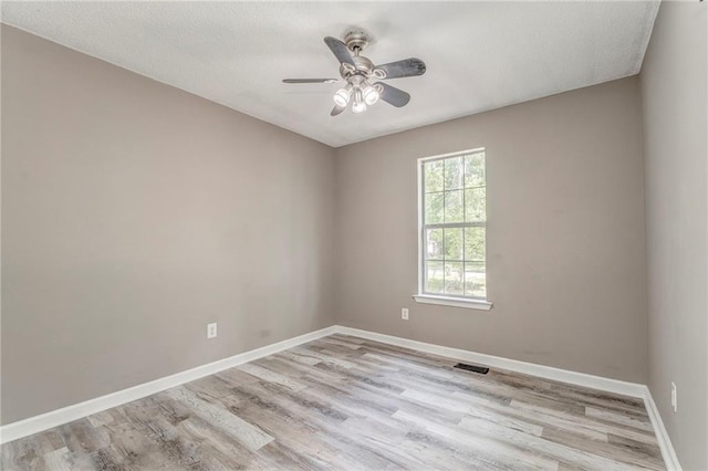 459 Bakers Bridge Cir, Douglasville, GA 30134 - unfurnished room with light wood finished floors, ceiling fan, and baseboards