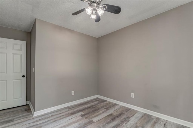 459 Bakers Bridge Cir, Douglasville, GA 30134 - empty room featuring ceiling fan, wood finished floors, baseboards, and a textured ceiling