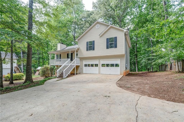 459 Bakers Bridge Cir, Douglasville, GA 30134 - split level home with covered porch, stairway, a garage, driveway, and a chimney