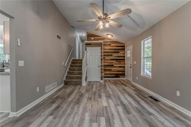 459 Bakers Bridge Cir, Douglasville, GA 30134 - entrance foyer featuring lofted ceiling, wood finished floors, a ceiling fan, stairway, and wooden walls