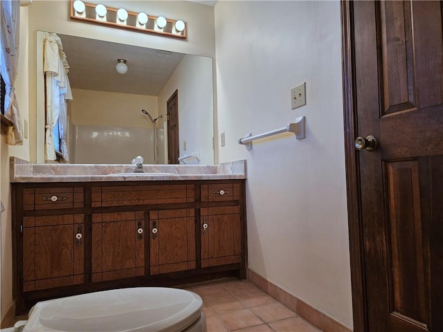 bathroom with tile patterned flooring, vanity, and curtained shower