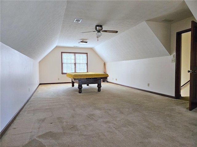 playroom with ceiling fan, lofted ceiling, light carpet, and a textured ceiling