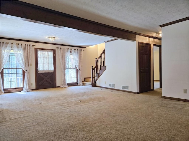 interior space with crown molding, light colored carpet, and a textured ceiling