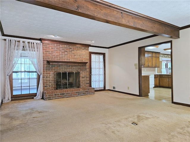 unfurnished living room with light carpet, crown molding, a fireplace, and beamed ceiling