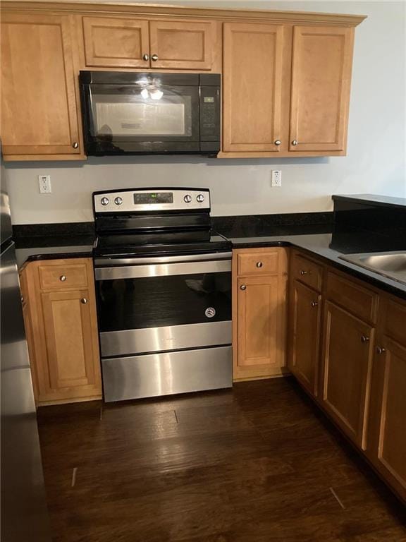 kitchen featuring electric stove, dark hardwood / wood-style flooring, and sink