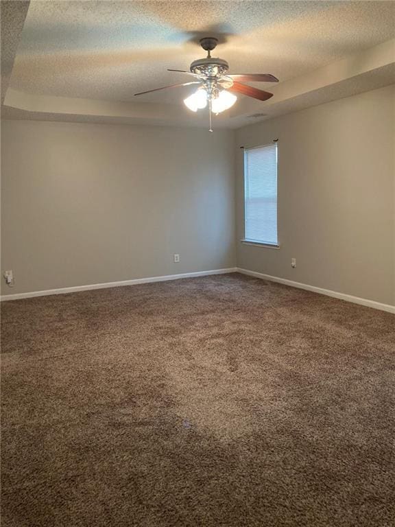 unfurnished room featuring ceiling fan, carpet floors, and a textured ceiling