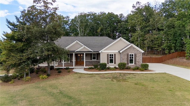 view of front of home with a front yard and covered porch