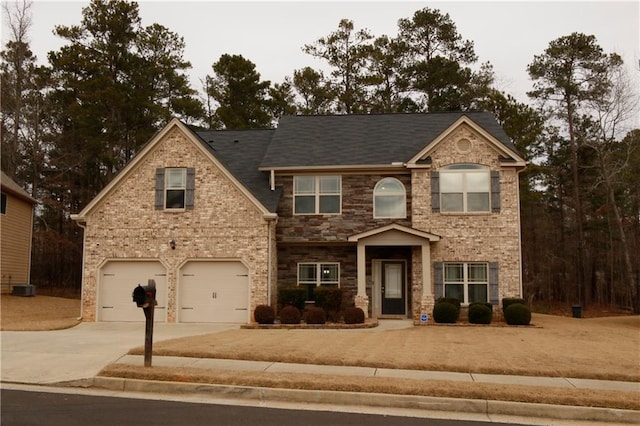 view of front facade with a garage and central AC unit