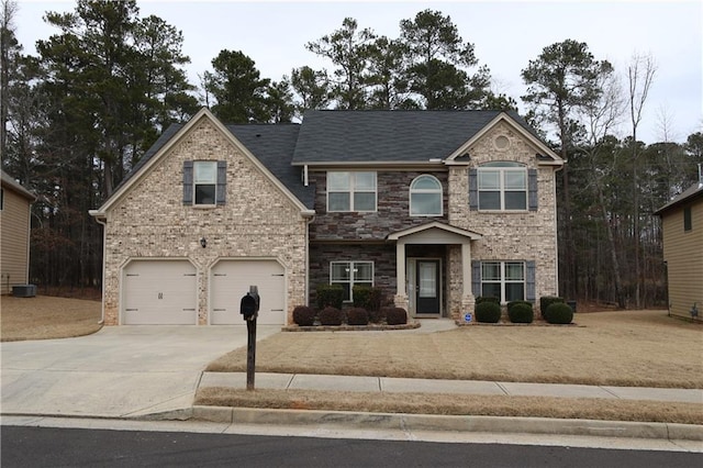 view of front of house with central AC unit and a garage