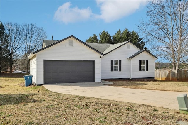 ranch-style house featuring a garage and a front yard