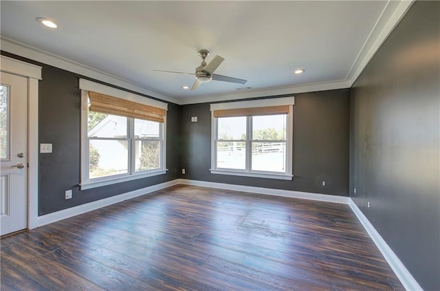 spare room featuring ceiling fan, dark wood-type flooring, and ornamental molding