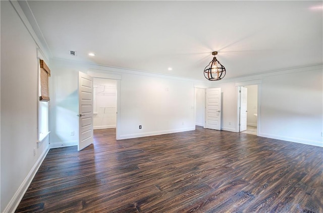 unfurnished room with crown molding, dark wood-type flooring, and a chandelier