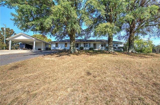 ranch-style home featuring a carport