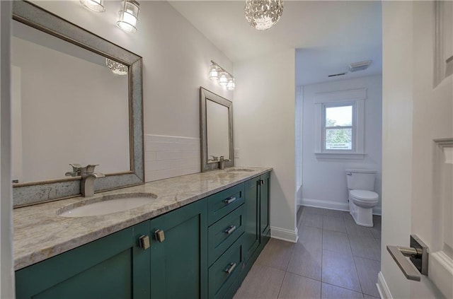 bathroom featuring tile patterned flooring, vanity, and toilet