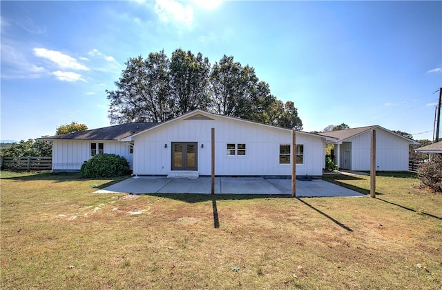 rear view of house featuring french doors, a patio, and a yard