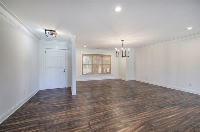 interior space with a notable chandelier, dark hardwood / wood-style floors, and crown molding