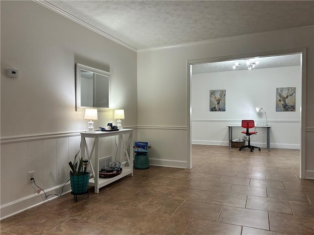 interior space with crown molding and a textured ceiling