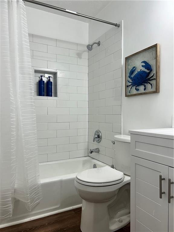 full bathroom with vanity, toilet, hardwood / wood-style floors, and shower / bath combo with shower curtain