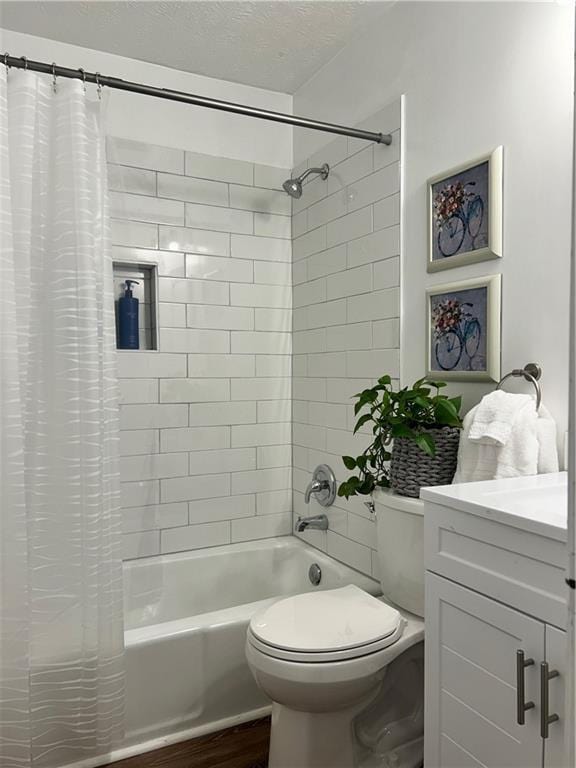 full bathroom featuring toilet, wood-type flooring, a textured ceiling, vanity, and shower / bath combo with shower curtain