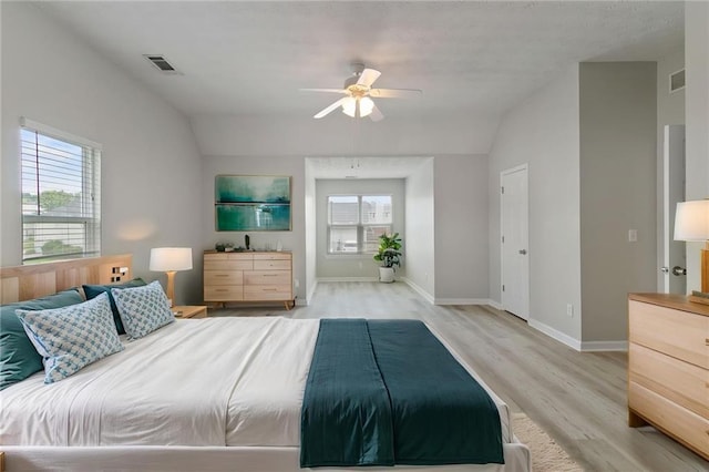 bedroom featuring vaulted ceiling, light wood-style flooring, baseboards, and a ceiling fan