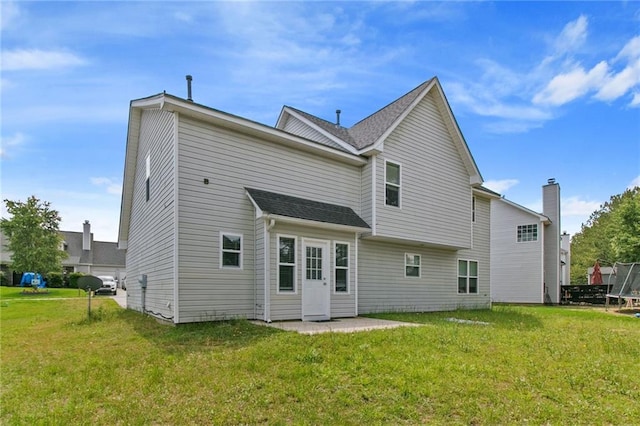 rear view of property with a lawn