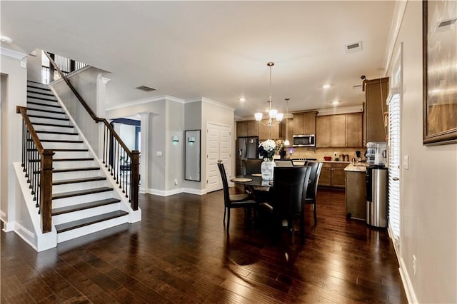 133 Canal St, Hampton, GA 30228 - dining space with stairs, baseboards, dark wood-style flooring, a chandelier, and ornamental molding