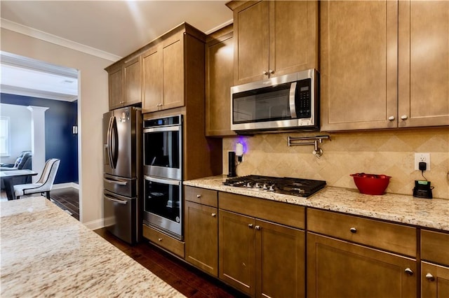 133 Canal St, Hampton, GA 30228 - kitchen featuring appliances with stainless steel finishes, crown molding, baseboards, tasteful backsplash, and dark wood-style floors