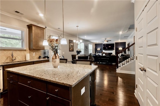 133 Canal St, Hampton, GA 30228 - kitchen featuring a sink, a kitchen island, crown molding, a ceiling fan, and plenty of natural light