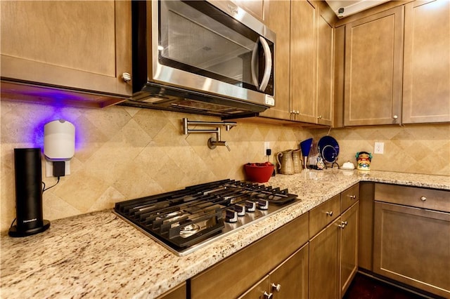 133 Canal St, Hampton, GA 30228 - kitchen with stainless steel appliances, tasteful backsplash, and light stone counters