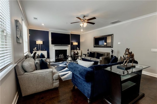 133 Canal St, Hampton, GA 30228 - living room featuring ceiling fan, wood finished floors, crown molding, a glass covered fireplace, and baseboards