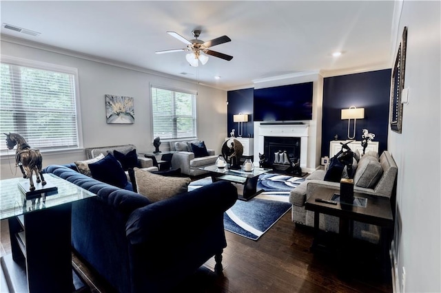 133 Canal St, Hampton, GA 30228 - living room featuring a ceiling fan, crown molding, dark wood finished floors, and a glass covered fireplace