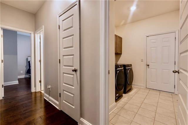 133 Canal St, Hampton, GA 30228 - clothes washing area with washer and clothes dryer, cabinet space, baseboards, and light wood-style floors