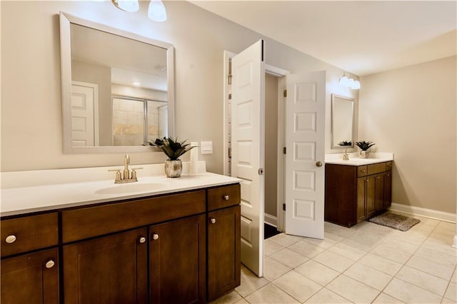 133 Canal St, Hampton, GA 30228 - bathroom featuring a shower stall, tile patterned flooring, two vanities, and baseboards