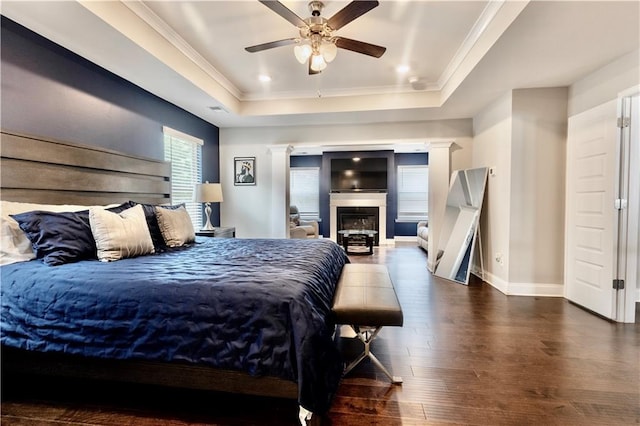 133 Canal St, Hampton, GA 30228 - bedroom with a raised ceiling, hardwood / wood-style floors, crown molding, baseboards, and a glass covered fireplace