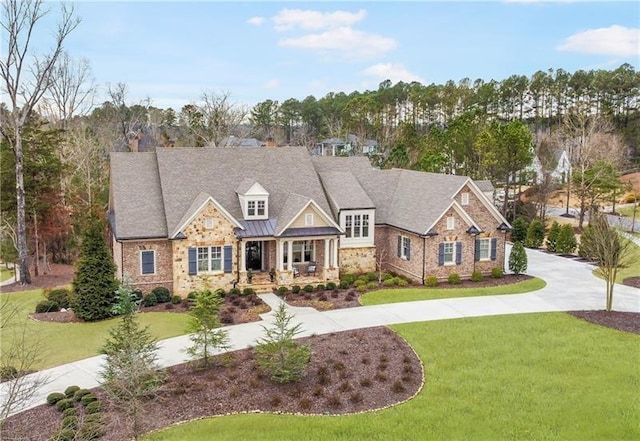 craftsman inspired home with a front lawn