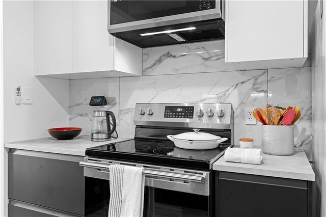 108 Vinings Forest Cir SE, Smyrna, GA 30080 - kitchen featuring stainless steel appliances, light countertops, backsplash, white cabinetry, and modern cabinets