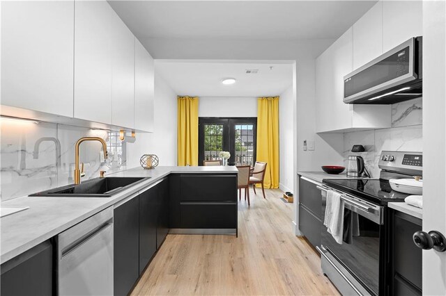 108 Vinings Forest Cir SE, Smyrna, GA 30080 - kitchen with appliances with stainless steel finishes, a sink, modern cabinets, and white cabinets
