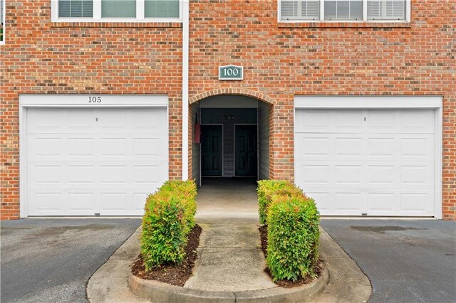 108 Vinings Forest Cir SE, Smyrna, GA 30080 - property entrance featuring a garage, brick siding, and driveway