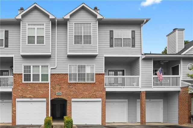 108 Vinings Forest Cir SE, Smyrna, GA 30080 - townhome / multi-family property with an attached garage, brick siding, driveway, and a chimney
