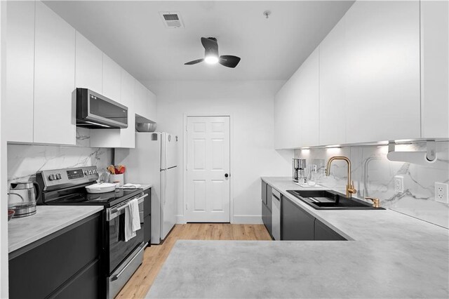 108 Vinings Forest Cir SE, Smyrna, GA 30080 - kitchen featuring stainless steel appliances, a sink, modern cabinets, a ceiling fan, and light countertops