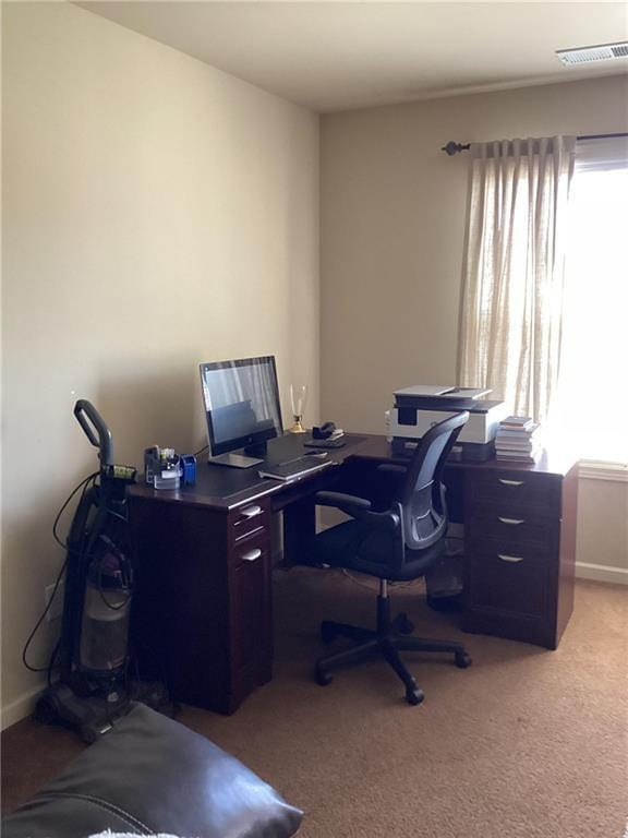 home office featuring visible vents, baseboards, and light colored carpet