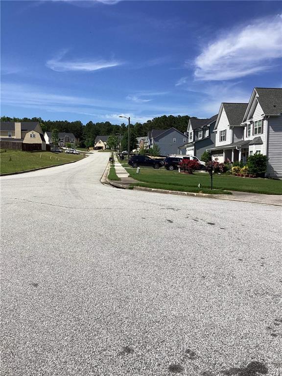 view of street with curbs, street lights, and a residential view