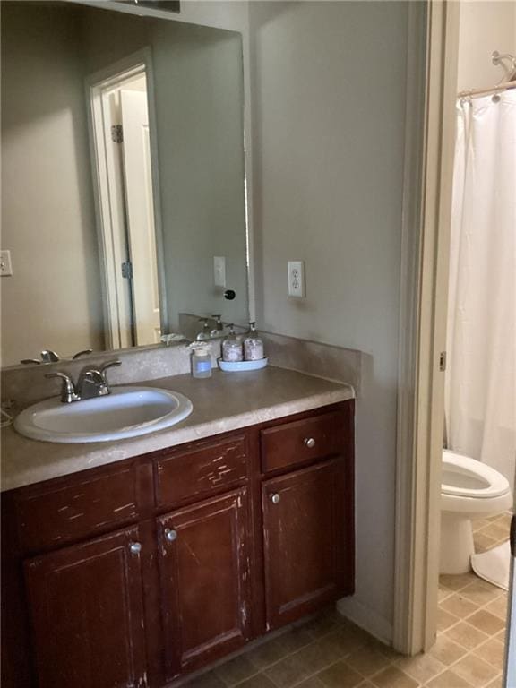 bathroom featuring tile patterned flooring, a shower with shower curtain, toilet, and vanity