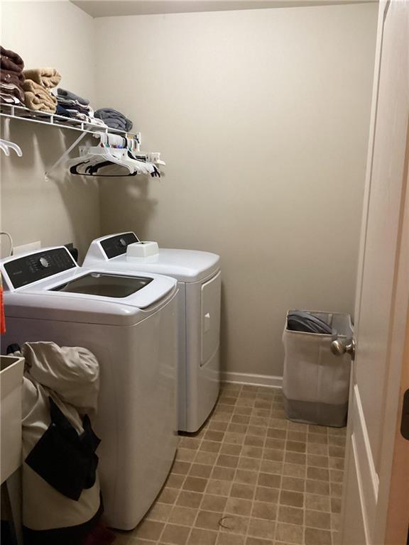 laundry area featuring separate washer and dryer and laundry area