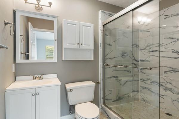 4841 Partee Trl, Social Circle, GA 30025 - full bathroom featuring a marble finish shower and vanity